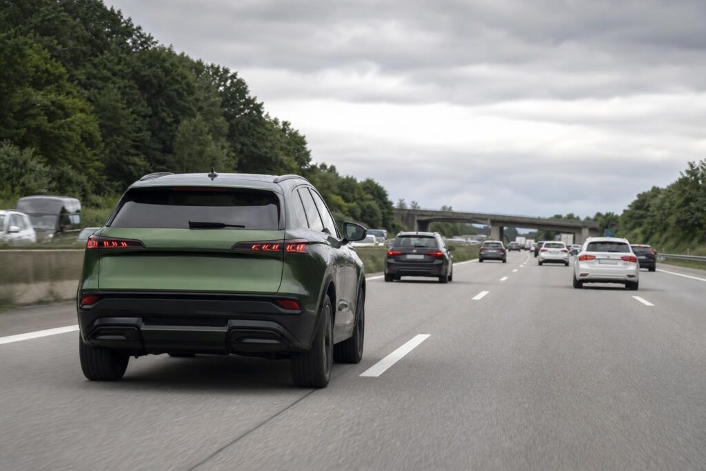Zöld SUV német autópályán több szürke, fekete és fehér autó között