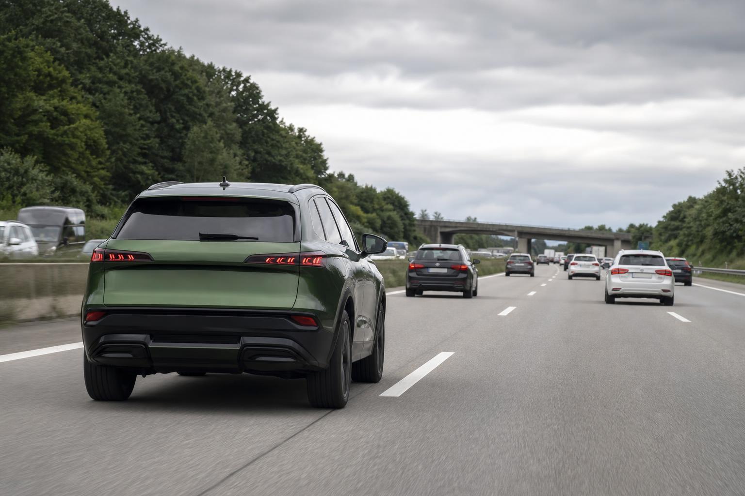 Zöld SUV német autópályán több szürke, fekete és fehér autó között